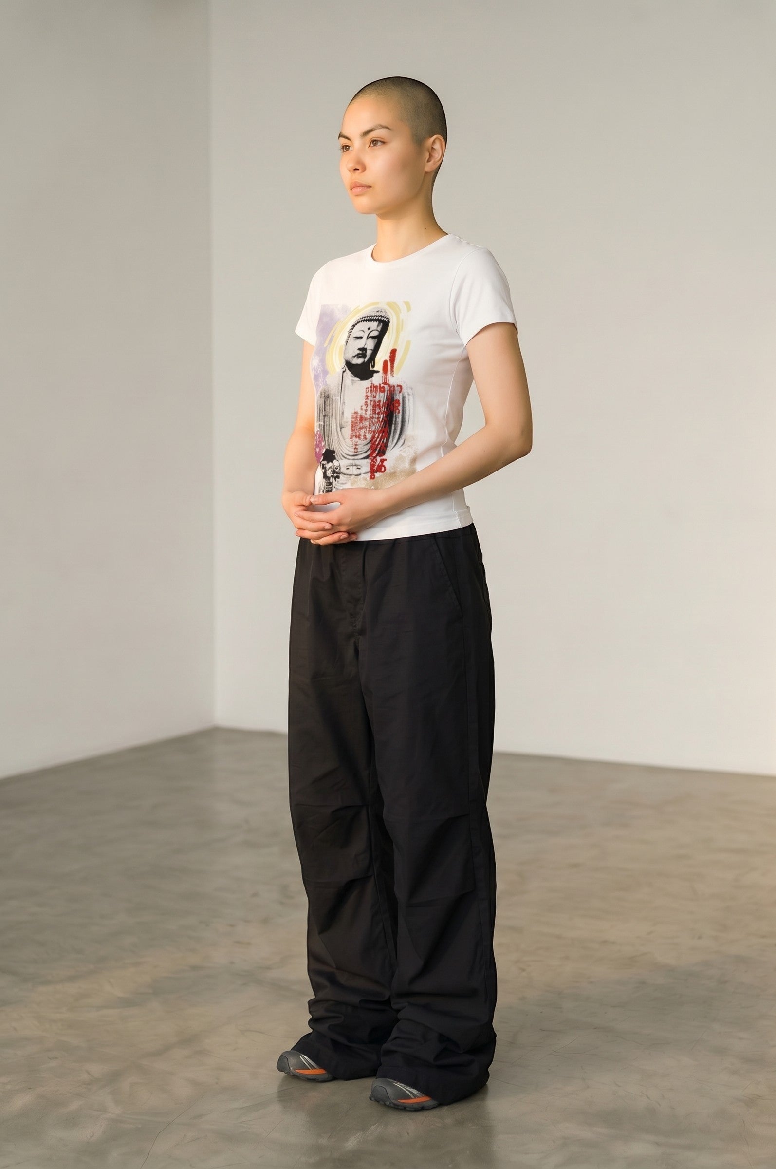 Estudio Mora white cotton t-shirt with a graphic print of a Buddha face and abstract colourful details.