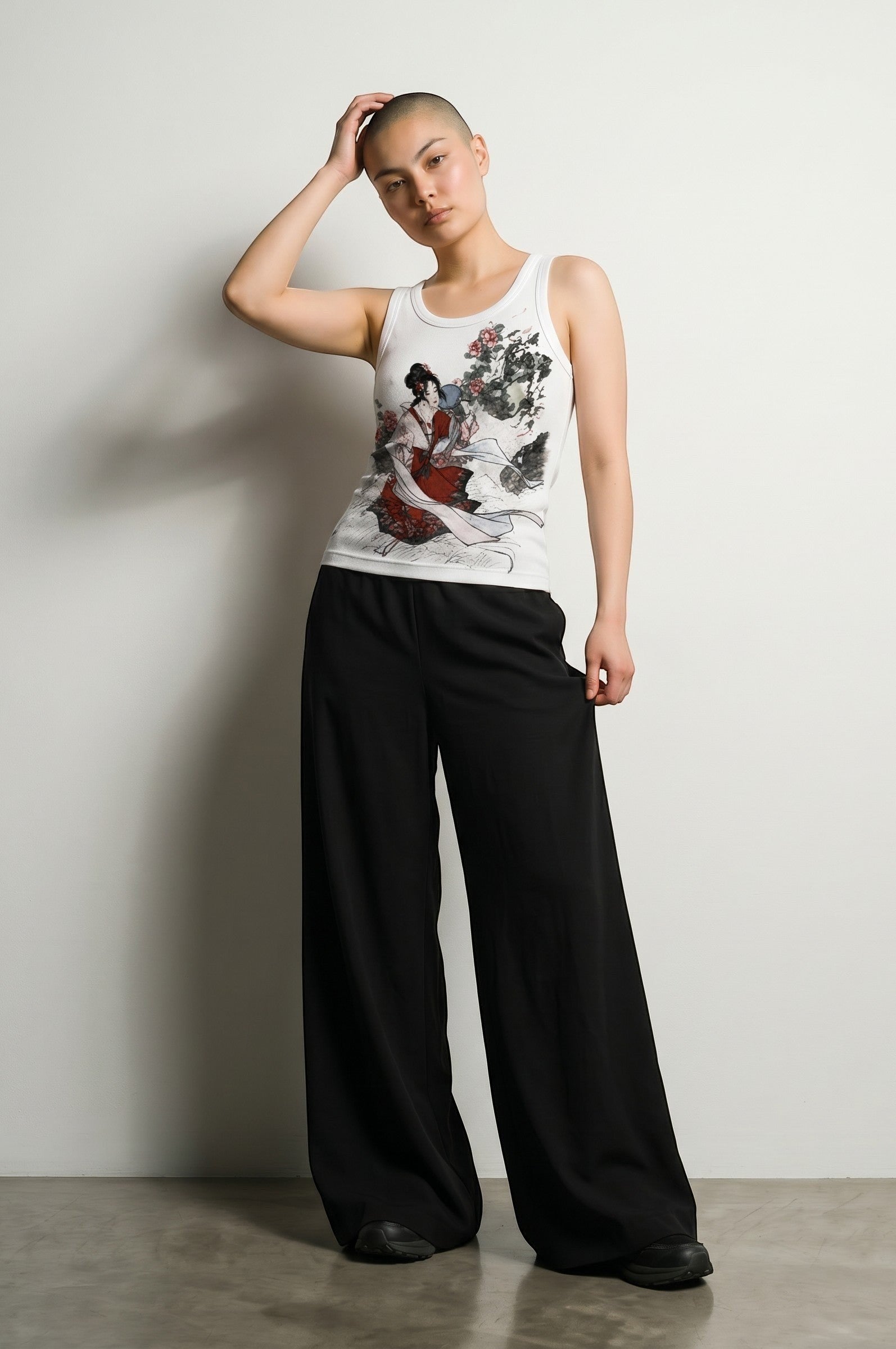 Estudio Mora white tank top with Japanese art print of a woman in red, black wide-leg pants.